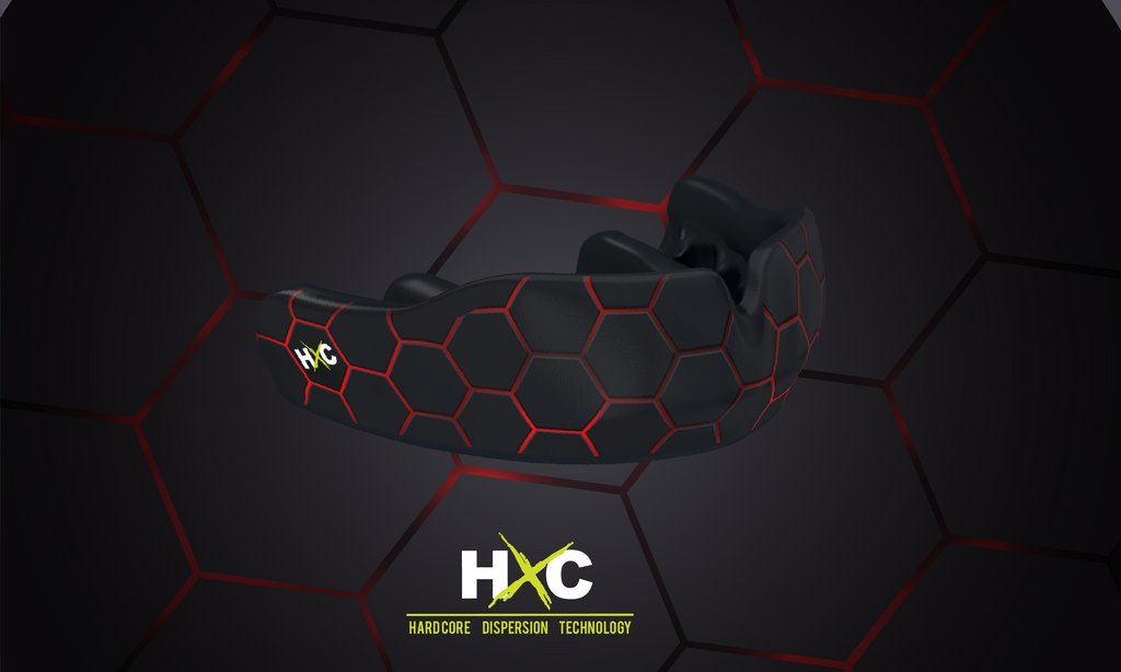 A professional athlete holds a custom fit mouthguard featuring advanced HXC technology.