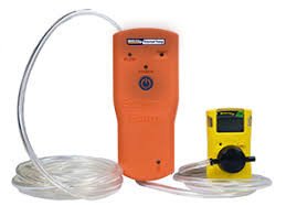 A professional gas clip technologies universal remote sampling pump sitting on a workbench.
