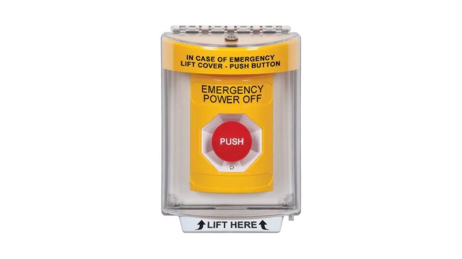 A red emergency power off push button mounted on an industrial wall.