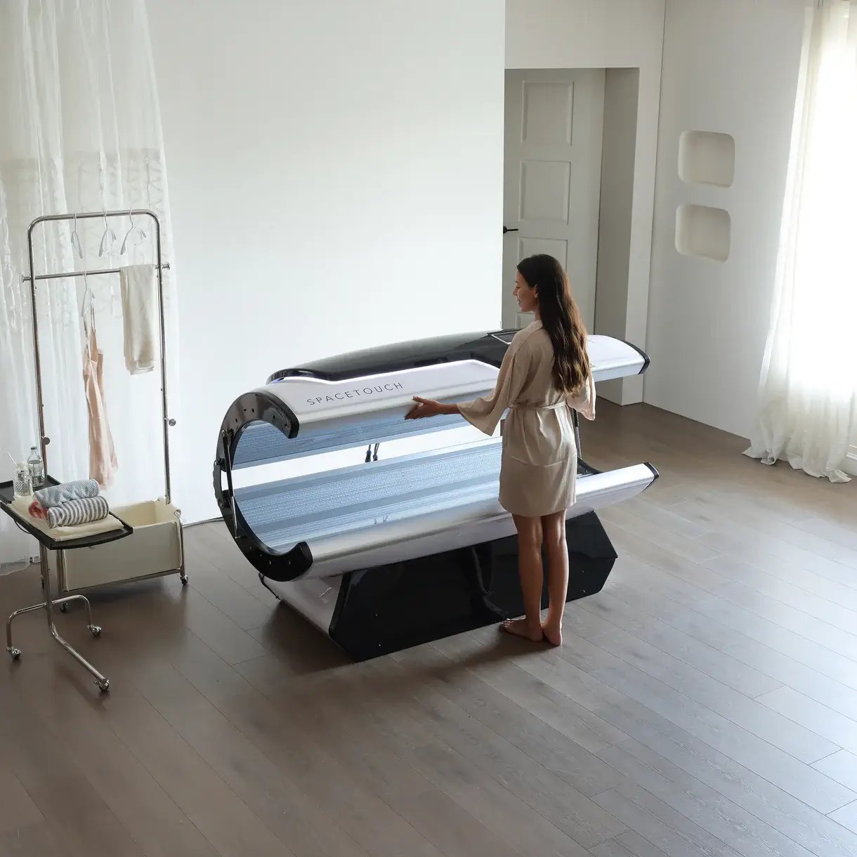 Essential maintenance items and a manual placed near a Sun Technologies Wolff Systems Solar Storm 24s tanning bed.