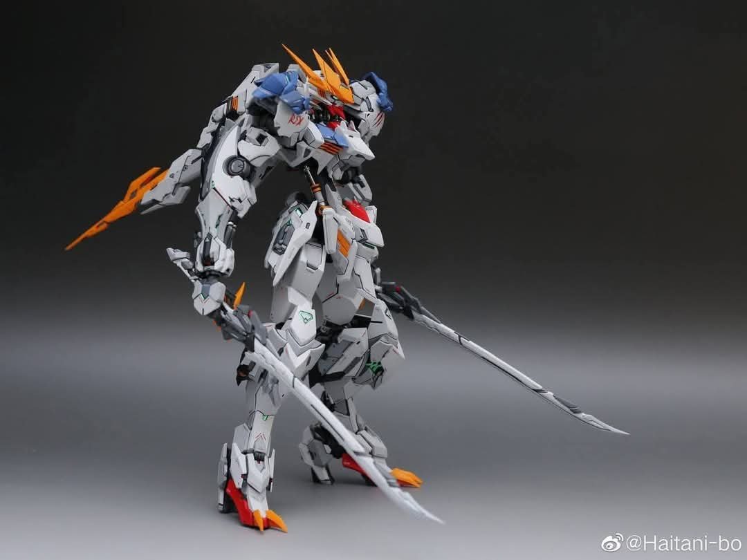 Professional precision screwdrivers arranged for assembling a detailed metal wolf model kit.